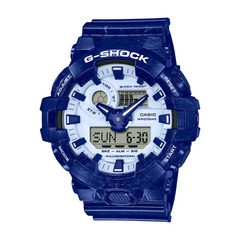 A blue CASIO G-SHOCK analog-digital watch with a resin band and a digital display showing the time.