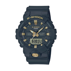 A Casio G-Shock GA-810B-1A9DR watch with a matte black resin band and a black analog-digital dial with gold accents.
