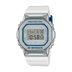 A Casio G-Shock digital watch with a white band, silver case, and blue accents. The watch features a digital display, a casing labeled 'G-SHOCK,' and buttons for various functions.