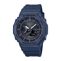 A blue CASIO G-SHOCK watch with a digital display and analog hands, featuring a carbon and resin construction.