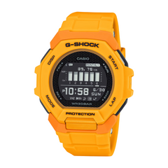 A Casio G-Shock watch with a bright orange band and casing, digital display showing time and various watch features, set against a white background.