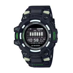 A digital CASIO G-SHOCK watch with a black band and case, featuring a black dial with green accents and a digital display.