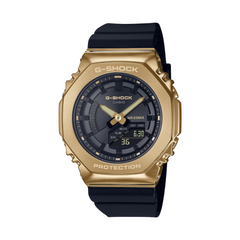 A Casio G-Shock watch with a black band and gold ion plated bezel, displaying a digital and analog time.