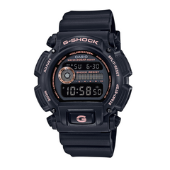 A black CASIO G-SHOCK DW-9052GBX-1A4 digital watch with a resin band and a digital display showing time, date, and various watch features.