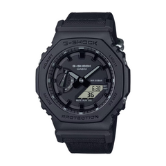 A black CASIO G-SHOCK watch with a digital display and analog hands, featuring a carbon case and a resin band.