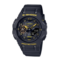A black CASIO G-SHOCK watch with a digital display and analog hands, featuring yellow accents on the watch face.