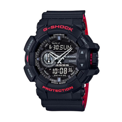 A black CASIO G-SHOCK watch with a digital display, world time features, and a red band.