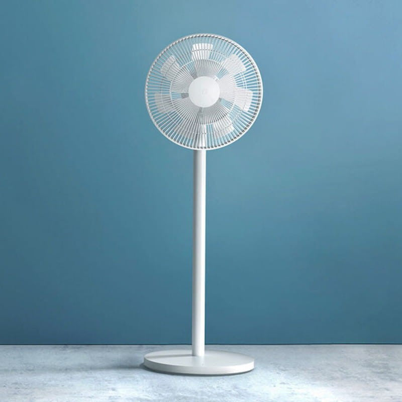 A white Xiaomi Smart Standing Fan 2 Pro with a cylindrical base and a circular guard, placed against a blue background.