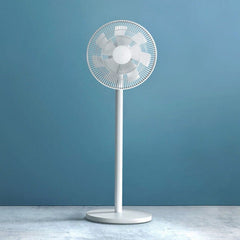 A white Xiaomi Smart Standing Fan 2 Pro with a cylindrical base and a circular guard, placed against a blue background.
