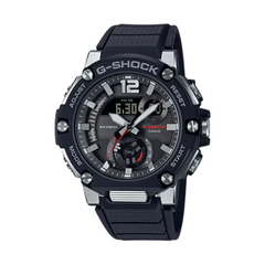 A Casio G-Shock watch with a black band and black case, featuring a digital display and analog hands.