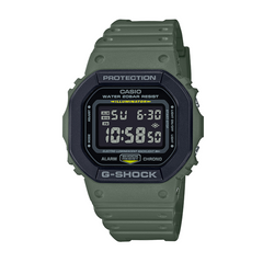 A green CASIO G-SHOCK DW-5610SU-3DR digital watch with a resin band and a digital display showing time, date, and various watch features.