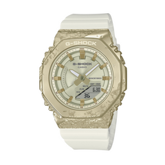 A Casio G-Shock watch with a gold ion plated bezel, white band, and digital display.