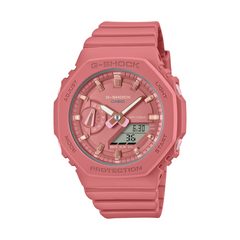 A pink CASIO G-SHOCK watch with an analog-digital display, world time feature, and a resin band.