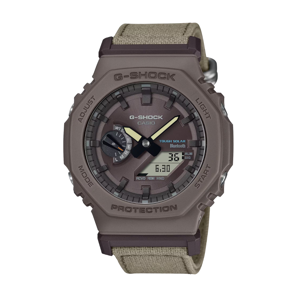 G-Shock watch with brown case and green strap on a white background