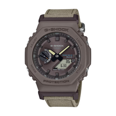 G-Shock watch with brown case and green strap on a white background