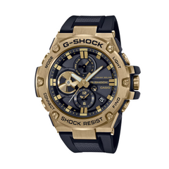 A Casio G-Shock watch with a black band and gold-colored case, featuring a digital display and analog hands.