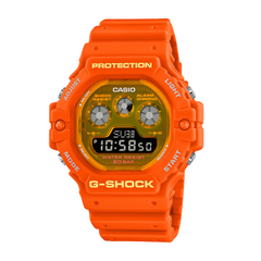 A Casio G-Shock digital watch in orange color with a resin band and a digital display, featuring multiple watch features such as world time, stopwatch, and alarm functions.