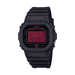 Black Casio G-Shock digital watch with red display on a white background