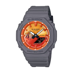A gray CASIO G-SHOCK watch with a digital display and analog features, including a red and orange dial.