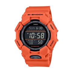 A Casio G-Shock digital watch in orange color with a resin band and a digital display showing time and various watch features.
