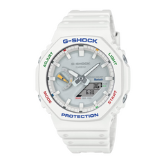 A white CASIO G-SHOCK watch with a digital display, resin band, and multicolored accents around the bezel.