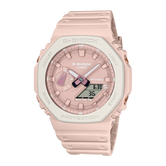 A pink CASIO G-SHOCK watch with an analog-digital display, world time feature, and a resin band.