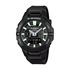 Black G-Shock watch with green digital display on a white background