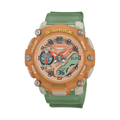 A Casio G-Shock watch with a green band and orange detailing on the dial, featuring analog and digital display.