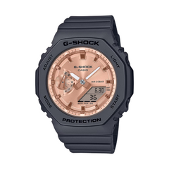 A Casio G-Shock watch with a black resin band and case, featuring a rose gold dial and digital display.