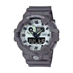 A CASIO G-SHOCK watch with a gray case and resin band, featuring a digital display and multiple watch features.