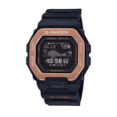 A Casio G-Shock watch with a black band and case, featuring a gold ion plated bezel and digital display.