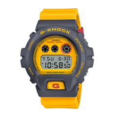 A Casio G-Shock DW-6900Y-9DR watch with a yellow band and grey case, displaying a digital watch face.