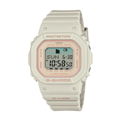 A CASIO G-SHOCK watch with a beige case and band, digital display showing time and various watch features, and a pink accent on the display.