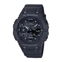 A black CASIO G-SHOCK watch with a digital display and analog hands, featuring a carbon case and resin band.