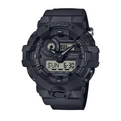 A black CASIO G-SHOCK analog-digital watch with a resin band and digital display showing the time.