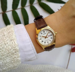 CASIO LTP-V006GL-7BUDF Women’s Analog Watch – Gold Leather Strap, White Roman Dial, Day & Date Display, Quartz Movement, Elegant Classic Design
