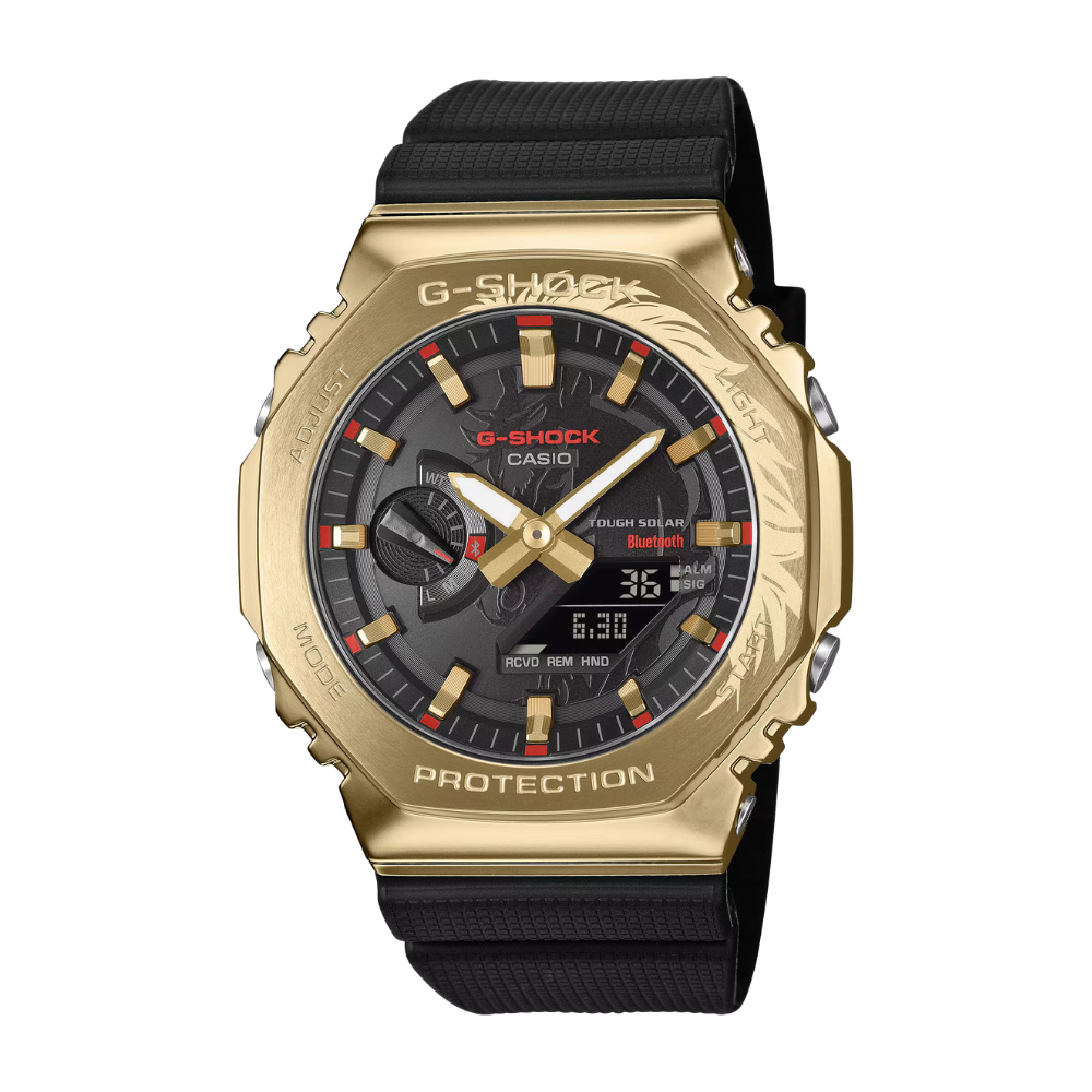 Gold Casio G-Shock watch with black strap on a white background