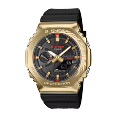 Gold Casio G-Shock watch with black strap on a white background