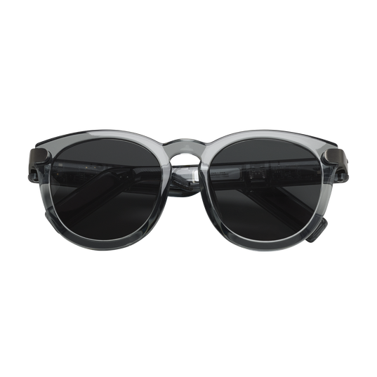 Sunglasses with a transparent frame and dark lenses on a white background