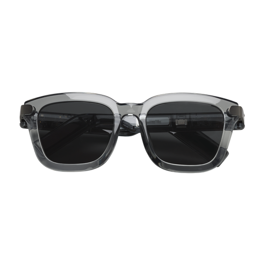 Sunglasses with transparent frame and dark lenses on a white background