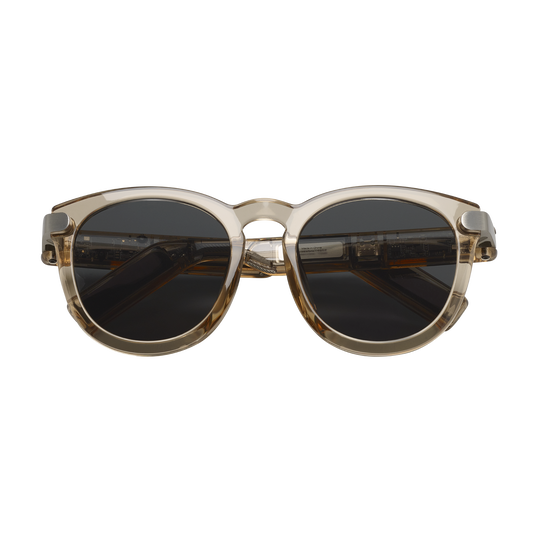 Sunglasses with a gold frame and dark lenses on a white background