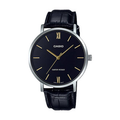 Casio watch with black leather strap and dark face on a white background